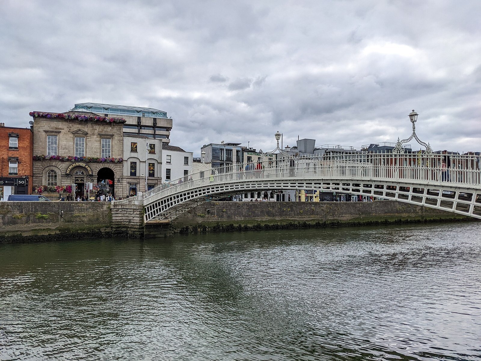 The Ha'penny Bridge arching over the River Liffey in central Dublin